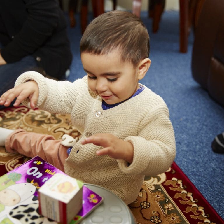 Baby playing with books