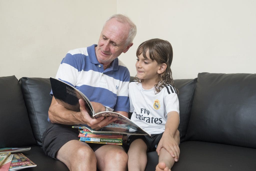child-and-volunteer-reading-together