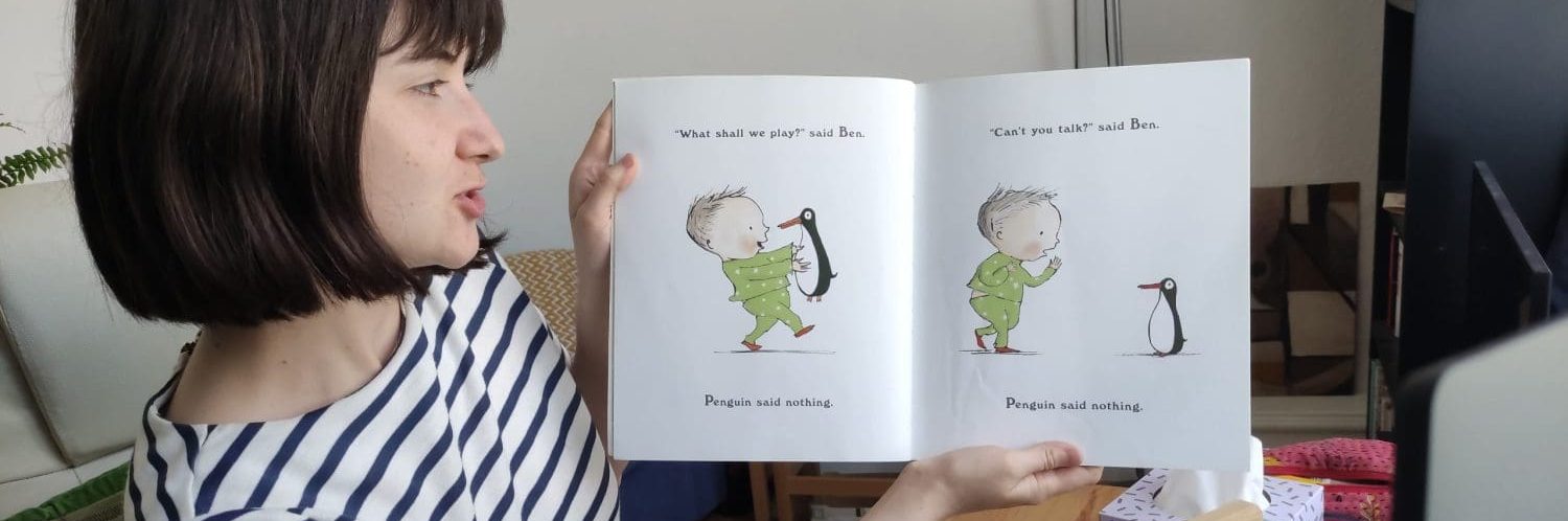 Online reading volunteer holding book