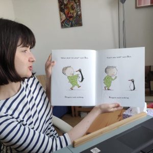Online reading volunteer holding book