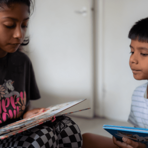 siblings-reading-together-at-home