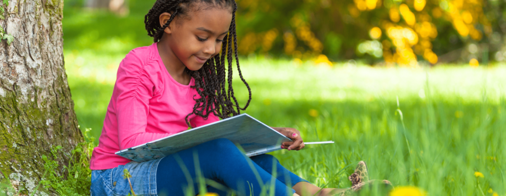 girl-reading-outside-under-tree