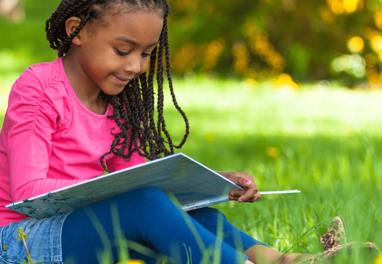 girl-reading-outside-under-tree