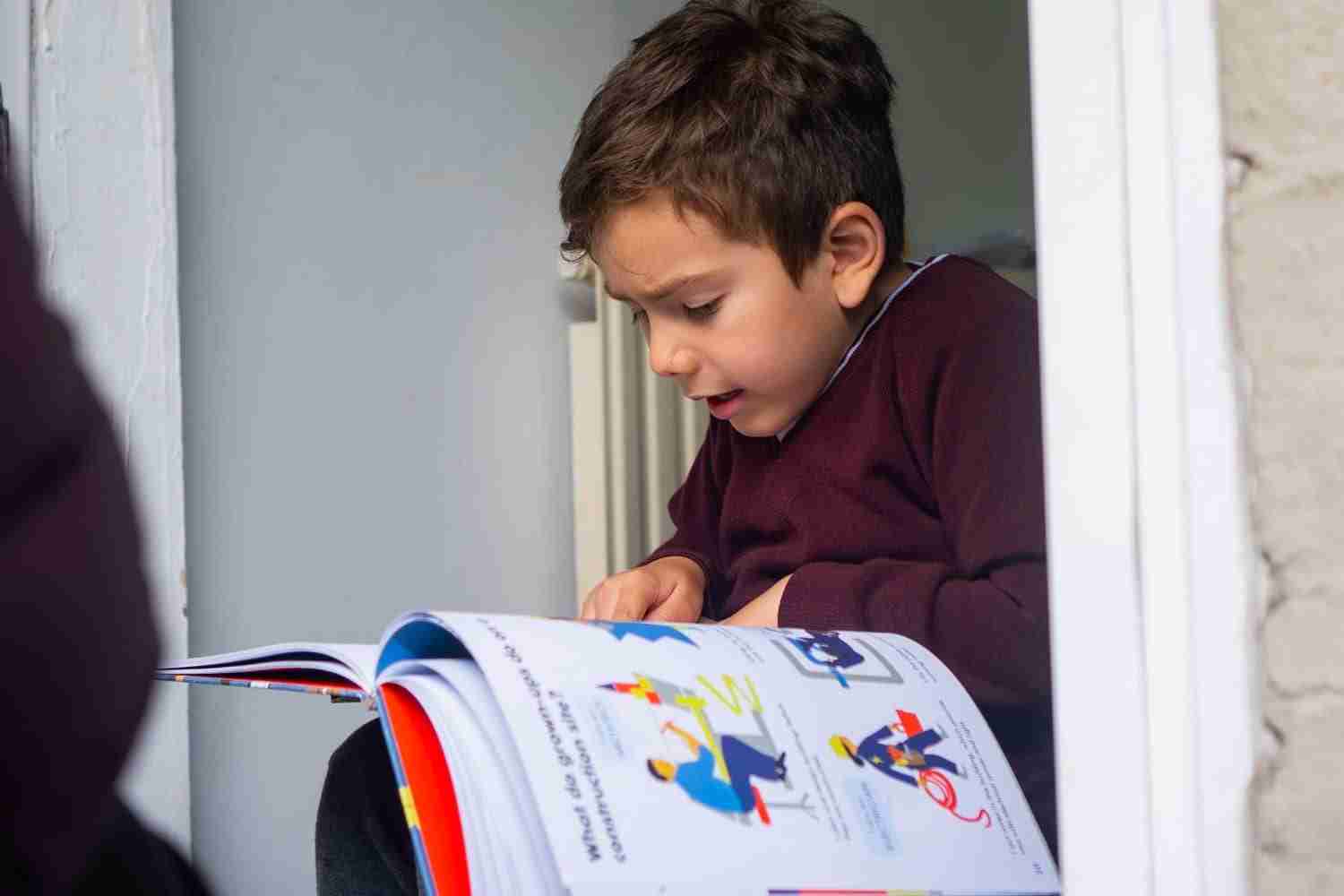 boy-reading-on-doorstep