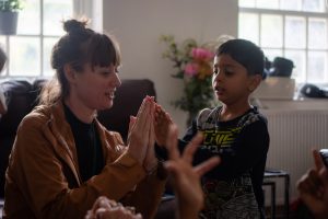 Rachel playing with a child during a reading session.